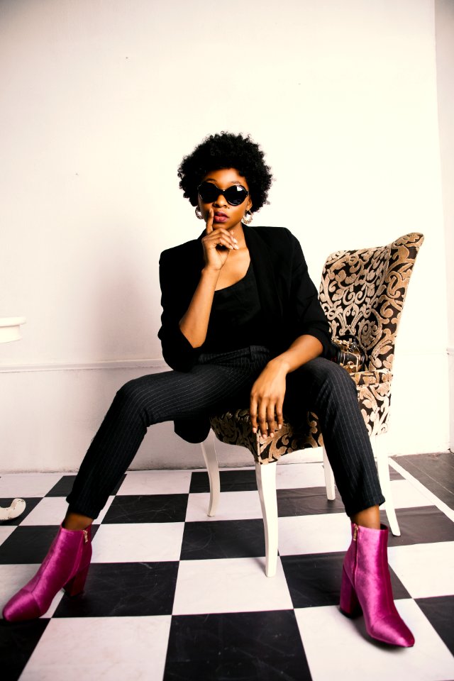 Woman In Black Blazer And Dress Pants Sitting On Chair photo