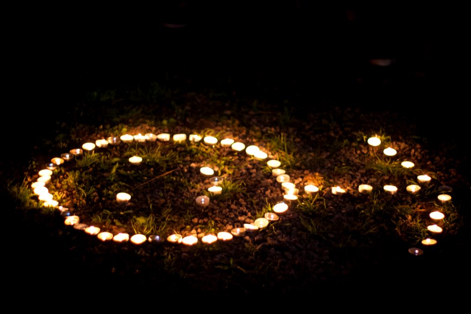 Arrow Shaped Lighted Tealight Candles On Grass