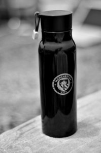 Selective Focus Photography Of Manchester City Sports Bottle photo
