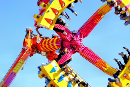 People Riding A Swing In The Amusement Park photo