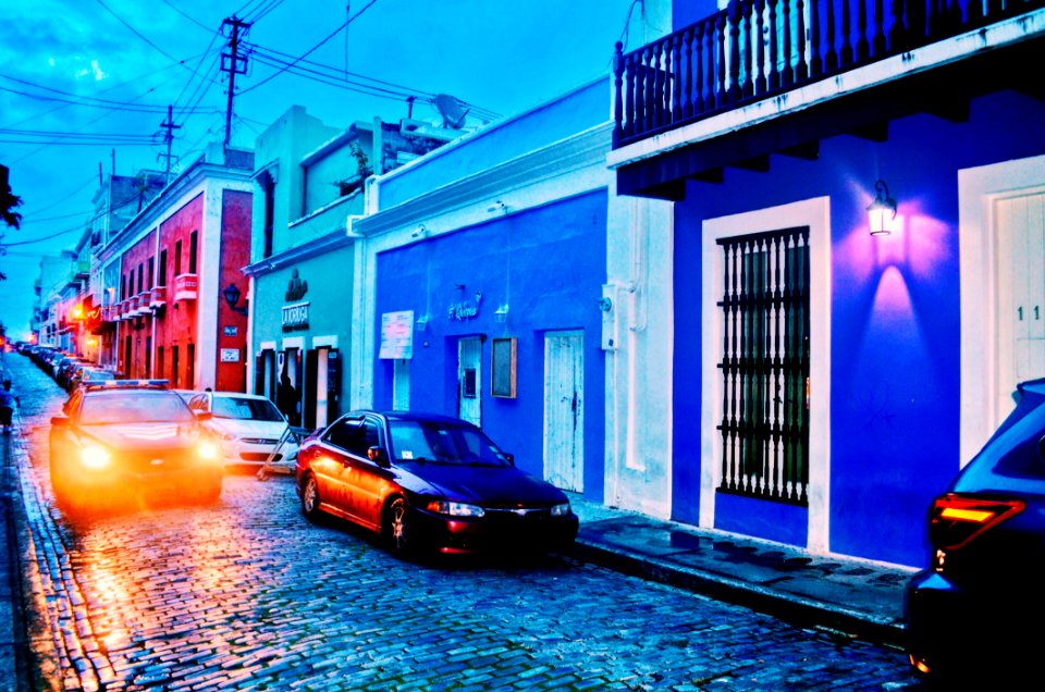 Black Sedan Parked Near Blue Building