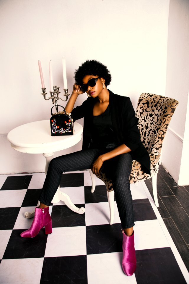 Woman In Black Shirt And Blazer Sitting On White And Brown Wooden Chair
