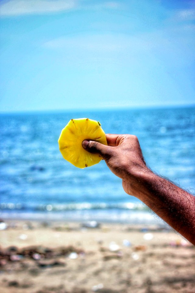 Person Holding Sliced Pineapple