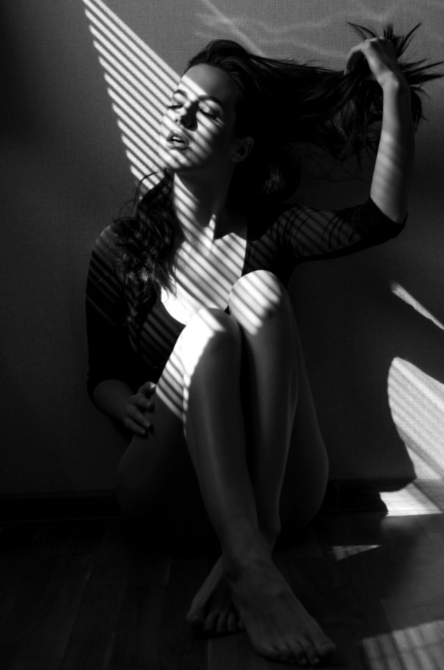 Greyscale Photo Of Sitting Woman photo