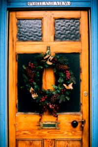 Brown Wooden Door With Pine Cone Wreath photo