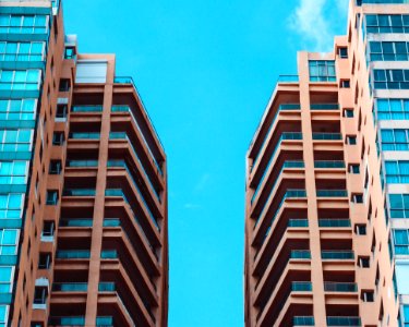Low Angle View Of Two High Rise Buildings Under Blue Sky photo