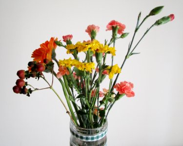 Clear Glass Vase With Red And Yellow Flowers photo