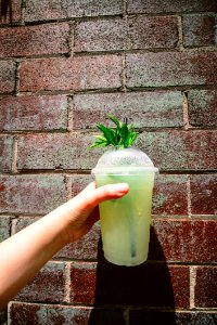 Person Holding Green Tea In Plastic Cup