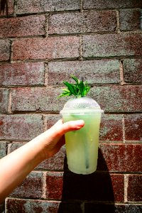 Person Holding Green Tea In Plastic Cup photo