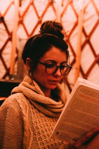 Photo Of Woman Wearing Gray Scarf Reading Book photo