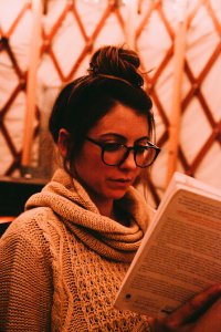 Photo Of Woman Wearing Gray Scarf Reading Book