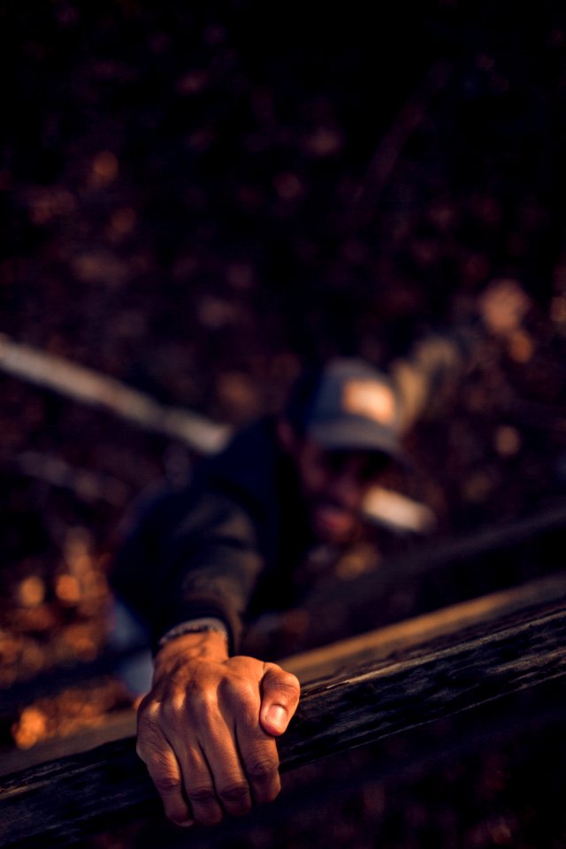 Man Holding On Wood