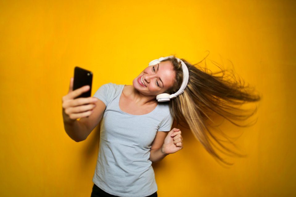 Photography Of A Woman Listening To Music