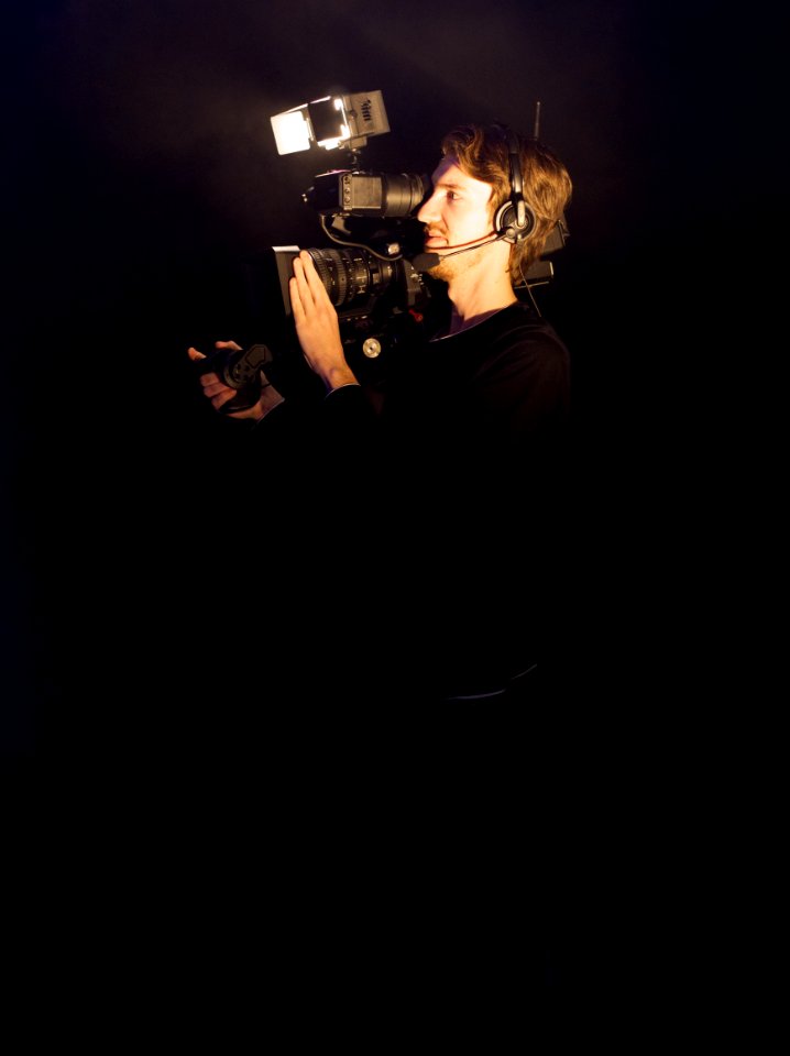 Man Wearing Black Long-sleeved Shirt Using Video Camera