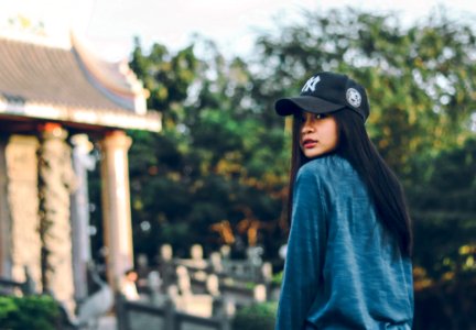 Woman Wearing Sweater And Baseball Cap
