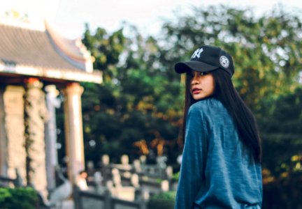 Woman Wearing Sweater And Baseball Cap photo