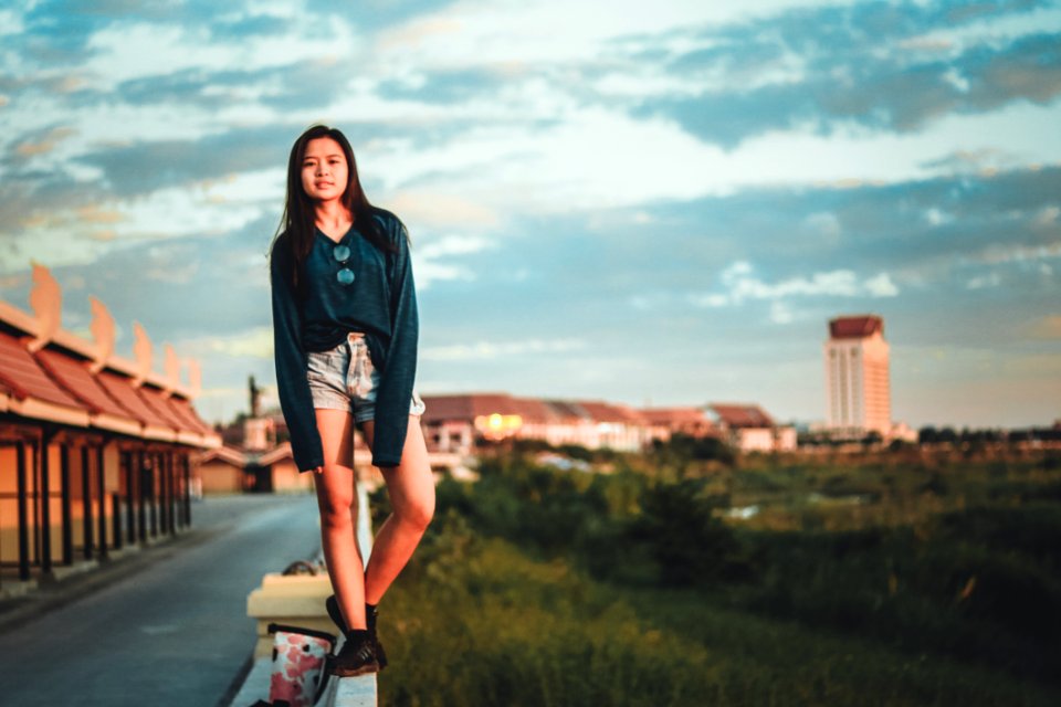 Woman Standing On Edge Of Wall photo