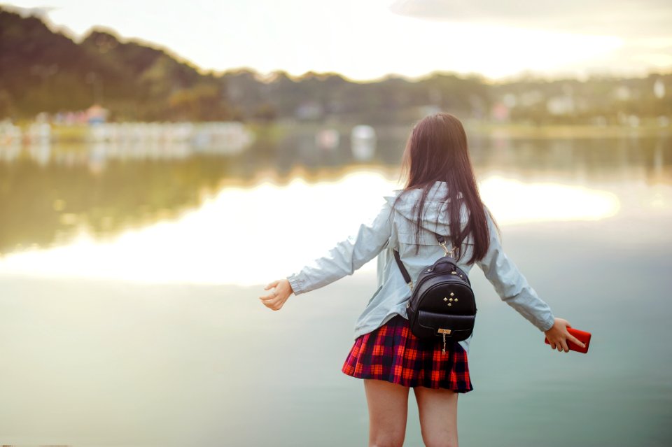 Selective Focus Photography Of Girl Near Body Of Water