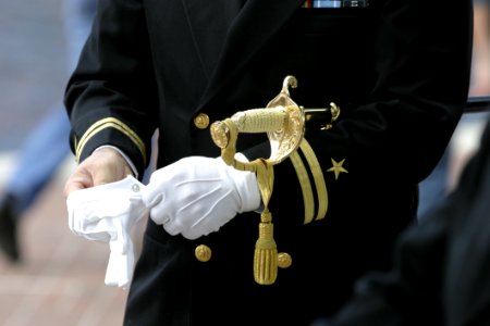 Man In Black Suit Wearing Gloves