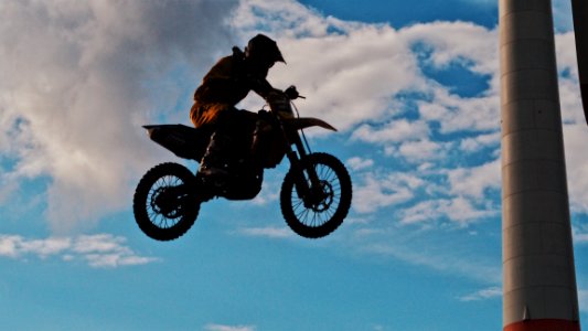 Man Riding Motocross Dirt Bike photo