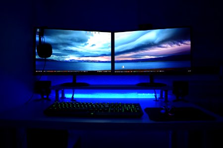 Two Computer Flat Screen Monitors Turned On