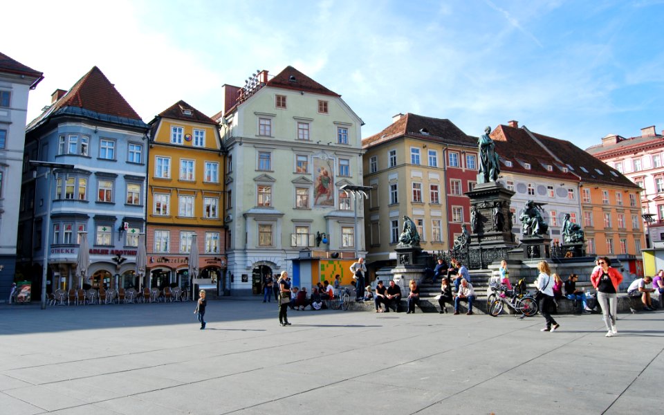 People Walking In Front Of Buildings
