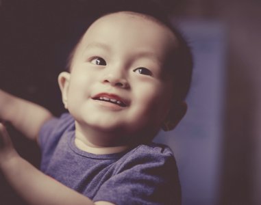 Close-Up Photography Of A Smiling Baby photo