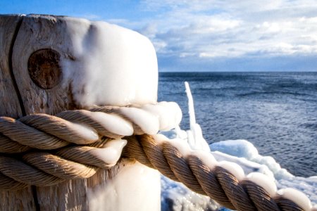 Brown Rope Tied On Wooden Post Beside Body Of Water