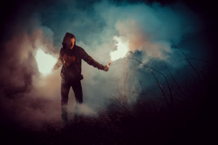 Man In Black Hoodie Holding Fire photo