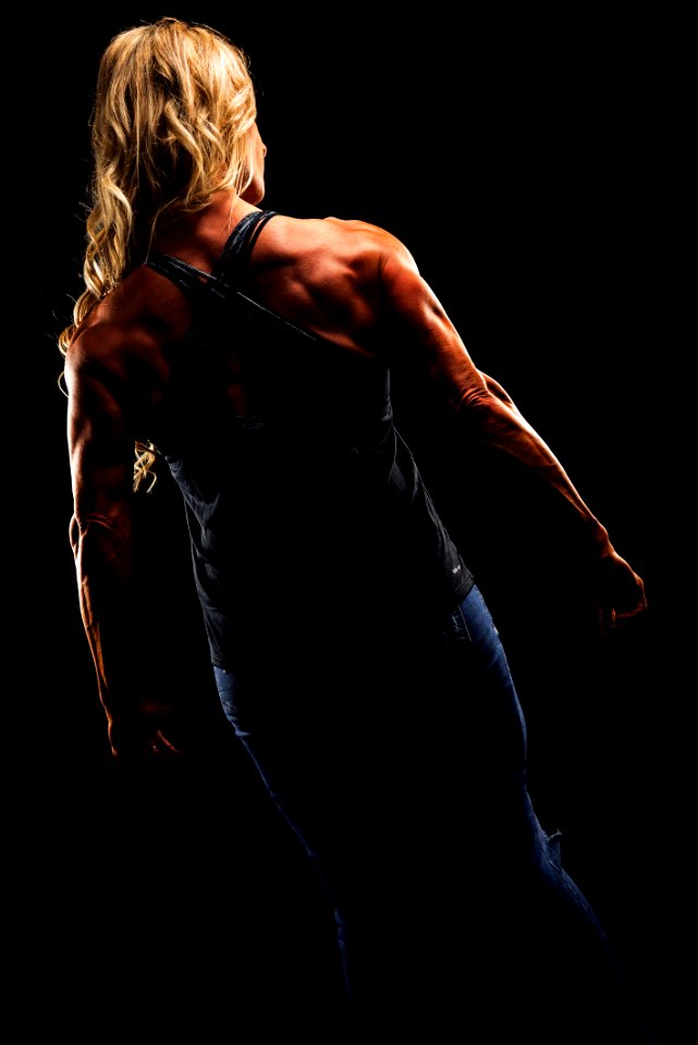 Woman Wearing Criss Cross Back Strap Top Flexing