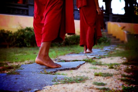 Two Human Wearing Monk Dress Walking On The Pathway