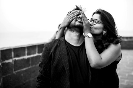 Grayscale Photography Of Woman Covering Eyes Of Man photo