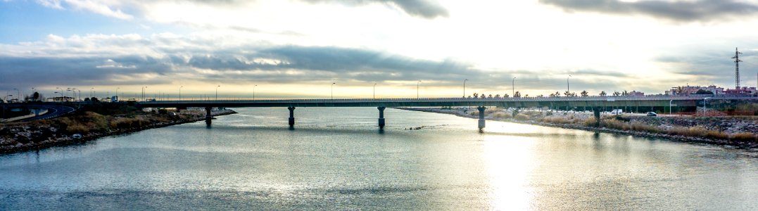 Panoramic Photography Of Bridge Under Cloudy Sky photo