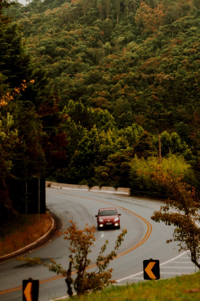 Red Car Travels On The Curved Road