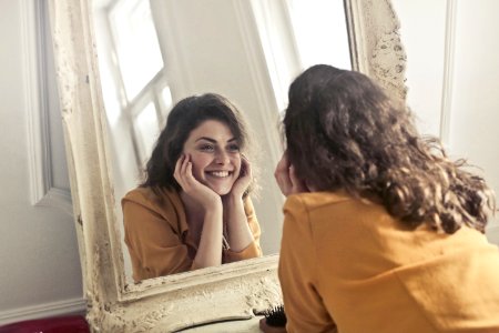 Photo Of Woman Looking At The Mirror photo
