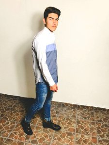 Man In White And Grey Dress Shirt And Blue Fitted Denim Jeans Outfit photo