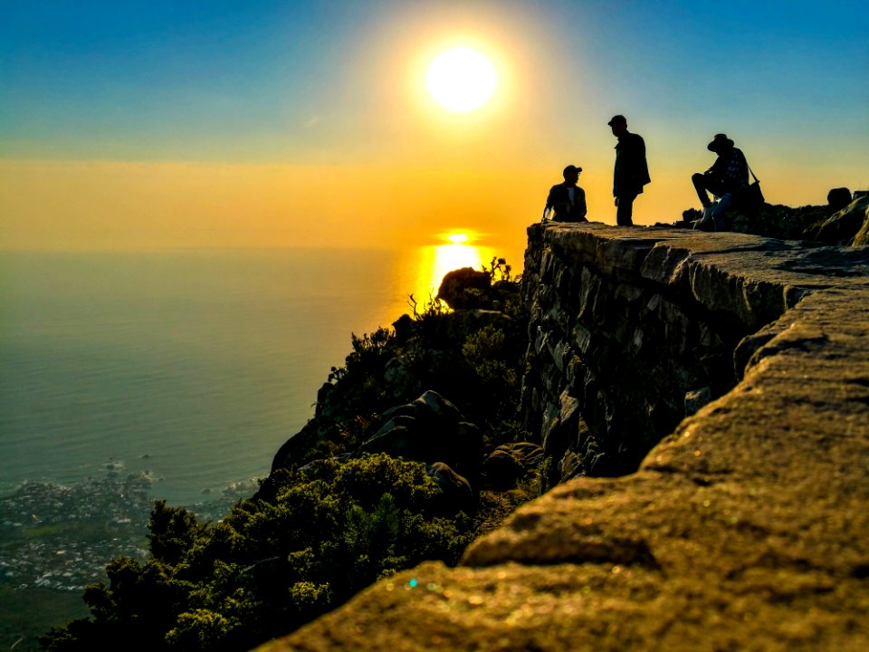 Three Men On Mountain Cliff