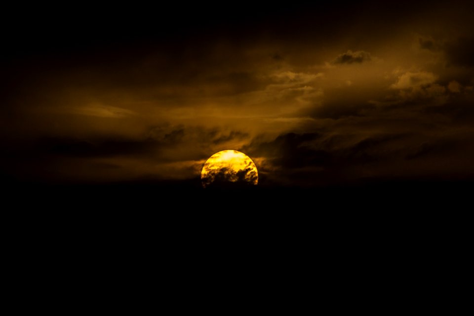 Photography Of Moon Behind Clouds