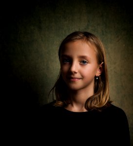 Smiling Girl With Blonde Hair Wearing Black Crew-neck Shirt