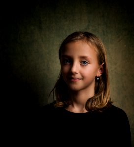 Smiling Girl With Blonde Hair Wearing Black Crew-neck Shirt photo