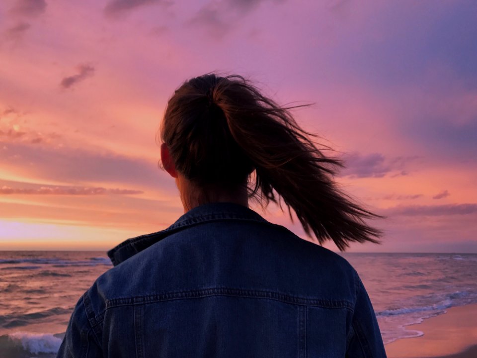 Woman Wearing Blue Denim Jacket Looking At The Beach photo