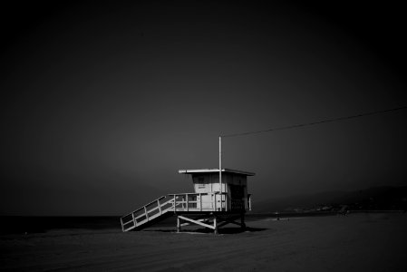 White Wooden Lifeguard House Near Shoreline photo