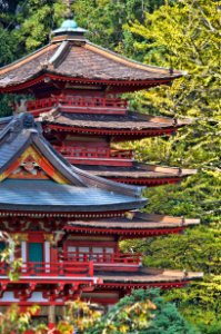 Red And Blue Temple Behind Green Leaf Trees At Daytime