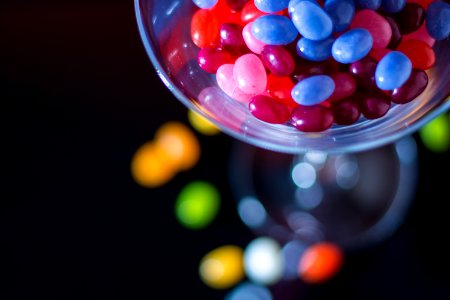 Selective Focus Photography Of Jelly Beans On Jar photo