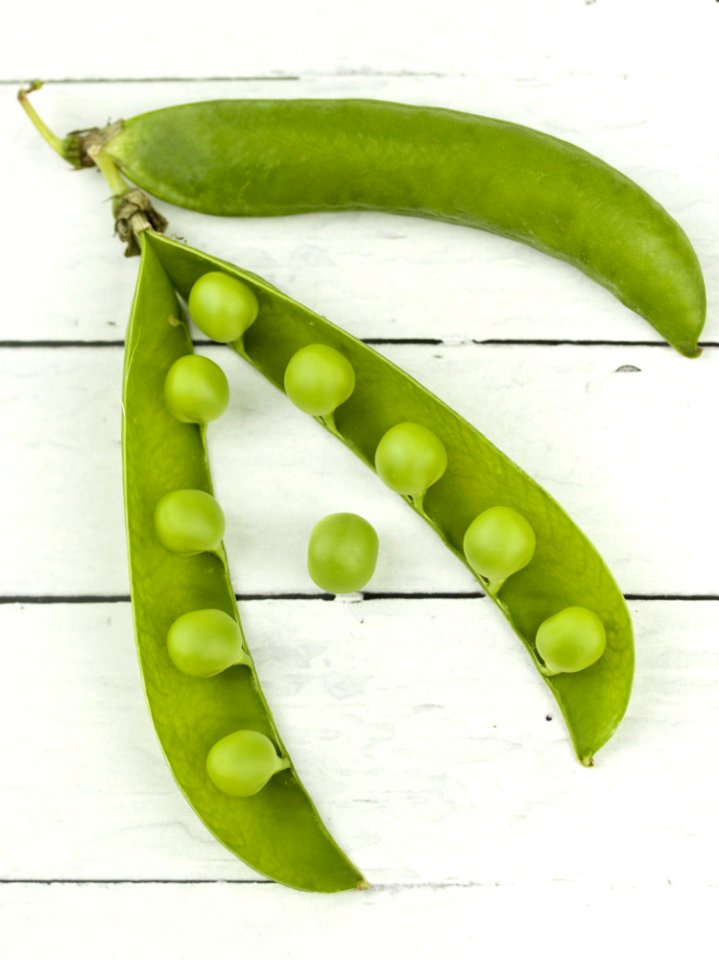 Green Peas Plant On White Surface