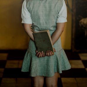 Woman Wearing Grey Dress Holding Book photo