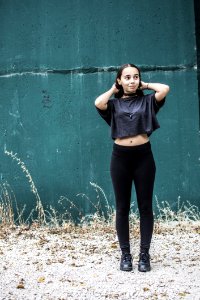 Woman Wearing Black Crew-neck Crop-top And Black High-waist Fitted Leggings photo