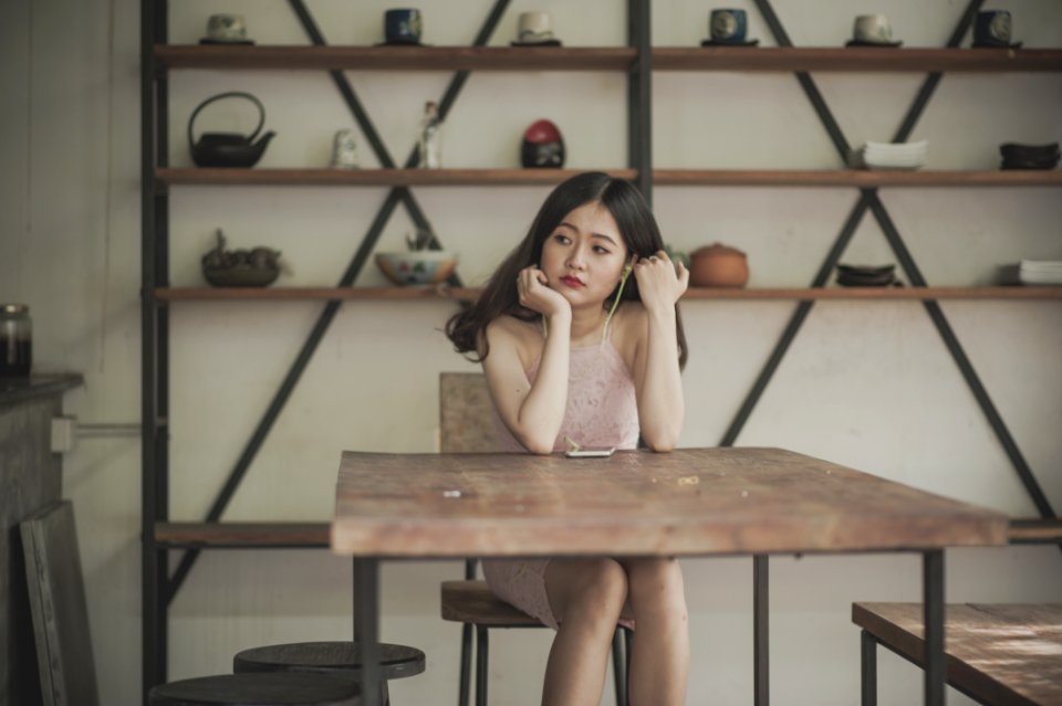 Photography Of A Woman Sitting On The Chair Listening To Music