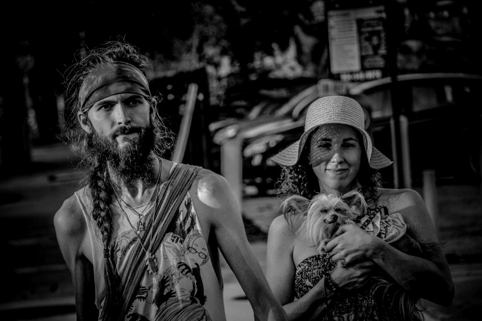 Grayscale Photo Of Couple With Small Dog