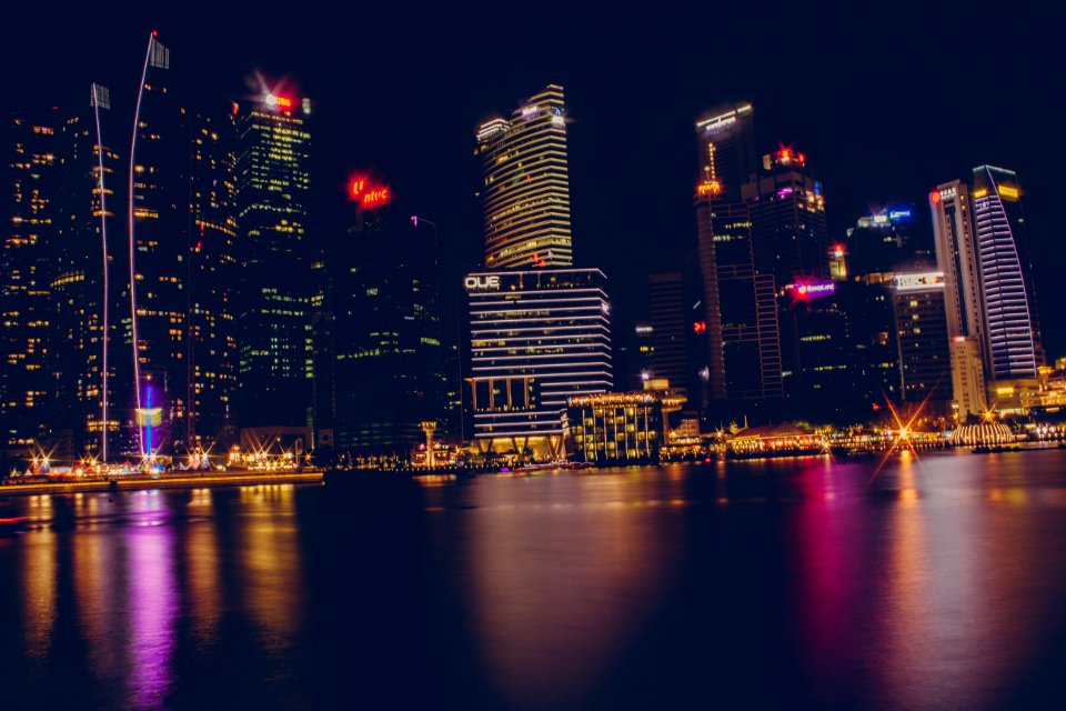 Buildings Near Body Of Water During Night Time photo